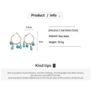 Detailed view of bohemian gold iron earrings with turquoise stones and size dimensions