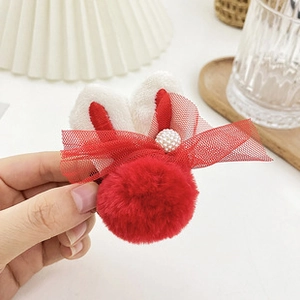 Detail showing red fluffy rabbit ear hair clip with mesh bow and pearl embellishment