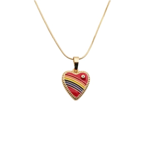 Detailed close-up of a golden heart pendant featuring red enamel and colorful stripes