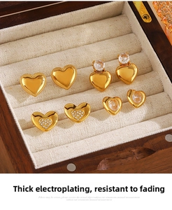 Macro view of four pairs of 18K gold-plated heart earrings with zircon inlay details
