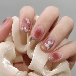 Short round camellia press-on nails with blush gradient and hand-painted floral design