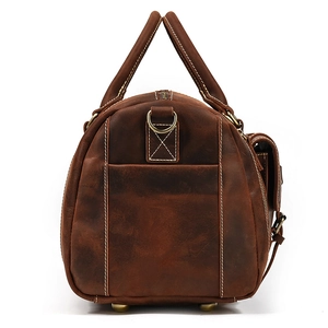 Side view of dark brown leather travel bag showing stitching and metal hardware details