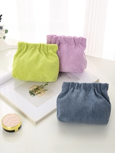 Detailed view of corduroy pouches in green, purple and blue with squeeze closure