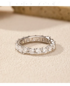 Macro shot of silver eternity ring with sparkling round cubic zirconia stones in prong setting