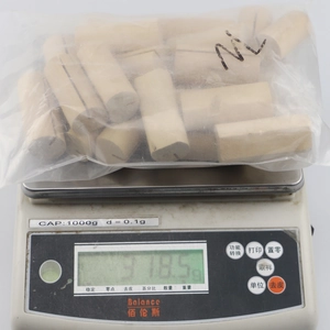 Macro view of 10-piece wooden calendar bases in plastic packaging on a digital scale