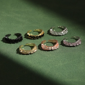 Detailed top view of double layer crisscross rings set with colorful baguette zircons