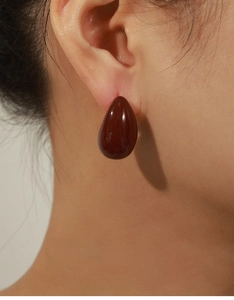 Detail of red enamel water drop earrings in copper material with French vintage design style