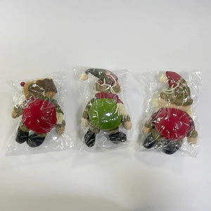 Detailed view of plush Christmas dolls with snowflake knit hats and boots set of three