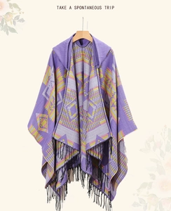 Detail of purple knitted poncho with ethnic geometric patterns and black fringe tassels