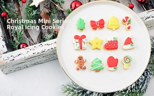 Mini Christmas royal icing cookies set including gingerbread man and snowflake on white plate