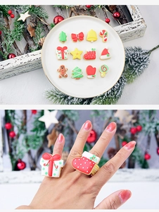 Close-up of festive Christmas rings featuring gingerbread man and tree designs