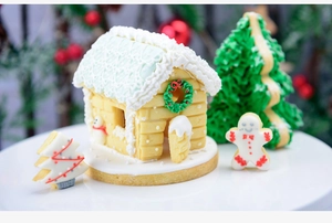 Detailed view of 3D gingerbread house cookies and DIY Christmas tree baking set