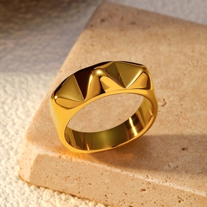 Macro detail of gold textured irregular geometric ring with modern industrial design