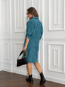 Detail of teal corduroy midi dress featuring textured fabric and black cuff buttons
