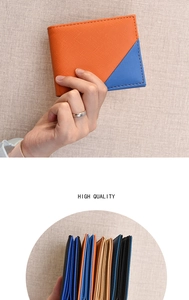 Detail of color-block bifold wallet showing orange and blue leather texture and layering