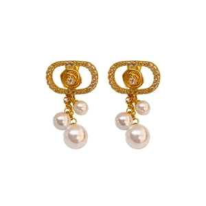 Elegant rose pattern earrings with pearls and crystals in a gold finish on white background