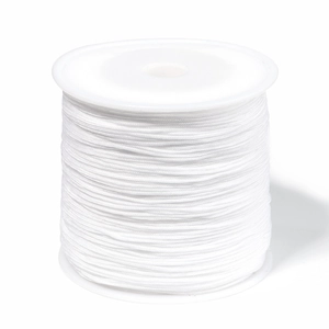Detailed macro view of white 0.8mm nylon cord roll for DIY jewelry weaving and crafts