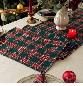 Classic red and green tartan table runner displayed in a festive Christmas table setting