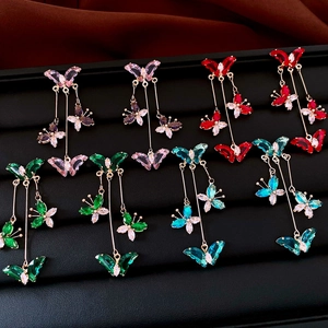 Detail of butterfly tassel earrings in purple, red, green, and blue zircon finishes
