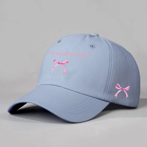 Light blue baseball cap with pink ribbon bow and I'm literally just a girl text
