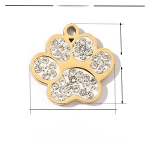 Detailed view of a golden dog paw pendant with white rhinestones and size parameters