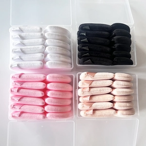 Bulk set of soft triangle powder puffs in four colors housed in clear organizer boxes