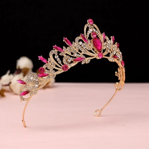 Detail of baroque crown featuring pink crystals and vintage hollowed metal texture