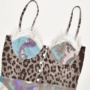 Detailed close-up of leopard print camisole with blue baroque patchwork and white lace trim