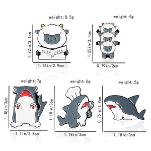 Detailed view of various shark and sheep enamel pins with exact size and weight dimensions