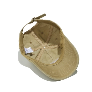 Detail of khaki cotton baseball cap interior showing 58-61cm adjustable size tag
