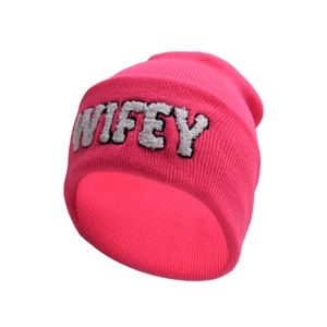 Close-up of fluffy white WIFEY letter embroidery on a vibrant pink knit beanie hat