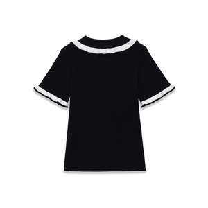 Detail of black ribbed knit polo shirt featuring white lettuce edge trim on collar and sleeves