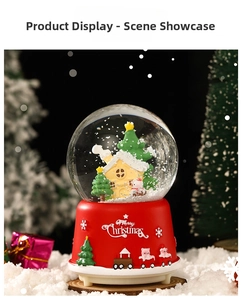 Detail of Christmas snow globe featuring a cozy cottage and embossed festive red base