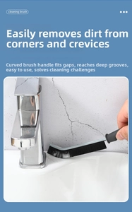 Macro detail of the curved handle and stiff black bristles of the gap cleaning brush