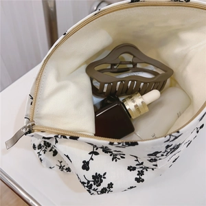 Interior detail view showing the storage capacity of a vintage floral cotton makeup bag
