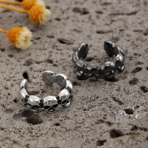 Punk style triple skull ear cuffs in antique silver and matte black metal finishes