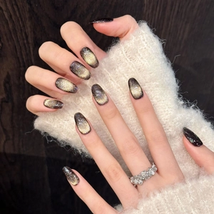 Golden cat eye press-on nails in long oval shape with sparkling metallic glitter finish