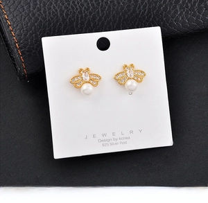 Detail of bee stud earrings with pearls and crystals on 925 silver needle cards