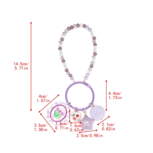 Detail of beaded keychain featuring a Good Luck star pendant and purple tulip charms