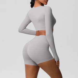 Detail of light purple yoga set showing high-waist shorts and long-sleeve crop top back view
