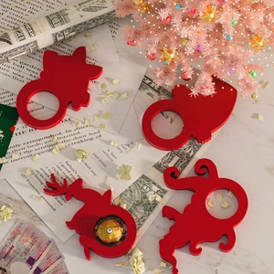 Set of 4 red Christmas reindeer and Santa desktop decorations on marble surface