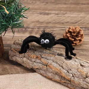 Detail of a fuzzy black Halloween spider hair clip with big white eyes on a natural wood log