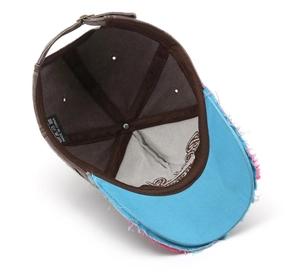 Detail of vintage washed canvas baseball cap showing frayed edges and interior care label