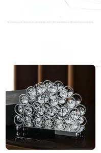 Detail shot of modern silver metal napkin holder with faceted crystal circular inlays