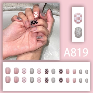 Pink and black checkerboard press-on nail set with glitter accents in 24 pieces