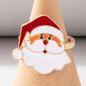 Detailed close-up of a gold-plated Santa Claus enamel ring on a wooden jewelry stand