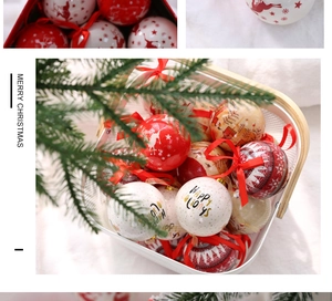 Close-up of red and white Christmas ornaments with ribbons in a white metal basket