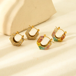 Close-up of hexagonal 18k gold-plated earrings with white and gradient rhinestones