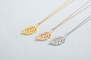 Detailed view of hollow leaf pendant necklaces in gold, rose gold and silver finish