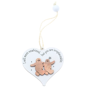 Detail of wooden heart ornament with irreplaceable friend quote and hanging bead decoration